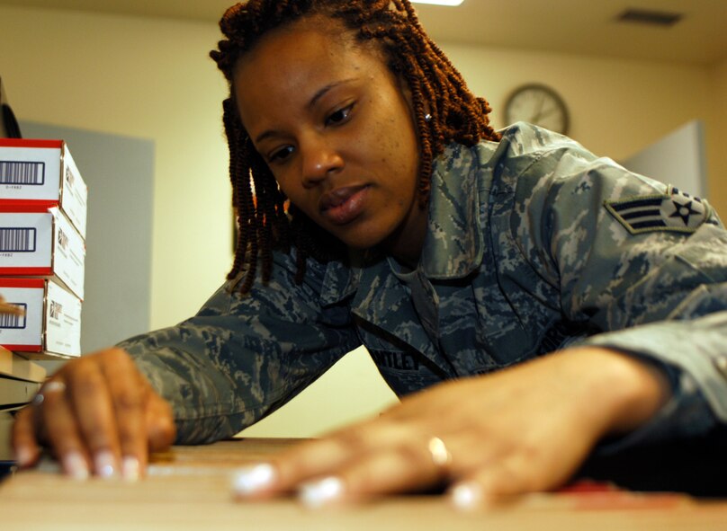 Senior Airman Toneisha Brantley flies paperwork for a customer March 4, 2011 at the military personnel flight career development section. The Georgia resident said she loves her job as a personnelist. (U.S. Air Force photo/Staff Sgt. J.G. Buzanowski)