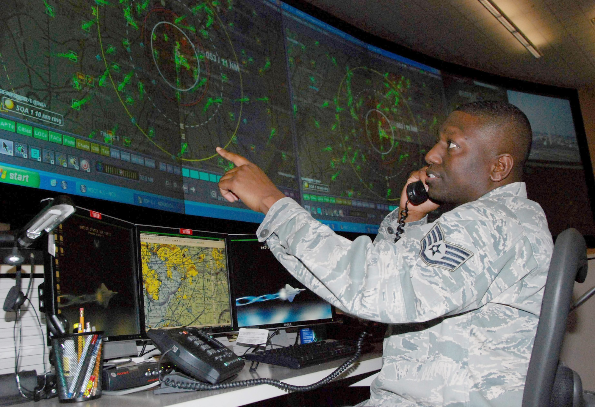 Staff Sgt. Jose Grimes monitors the radar March 8, 2011, at the Air Force Rescue Coordination Center at Tyndall Air Force Base, Fla., as he coordinates with another agency during a search-and-rescue mission. Sergeant Grimes is a search-and-rescue duty officer assigned to the AFRCC. (U.S. Air Force photo/Maj. Steve Burke)