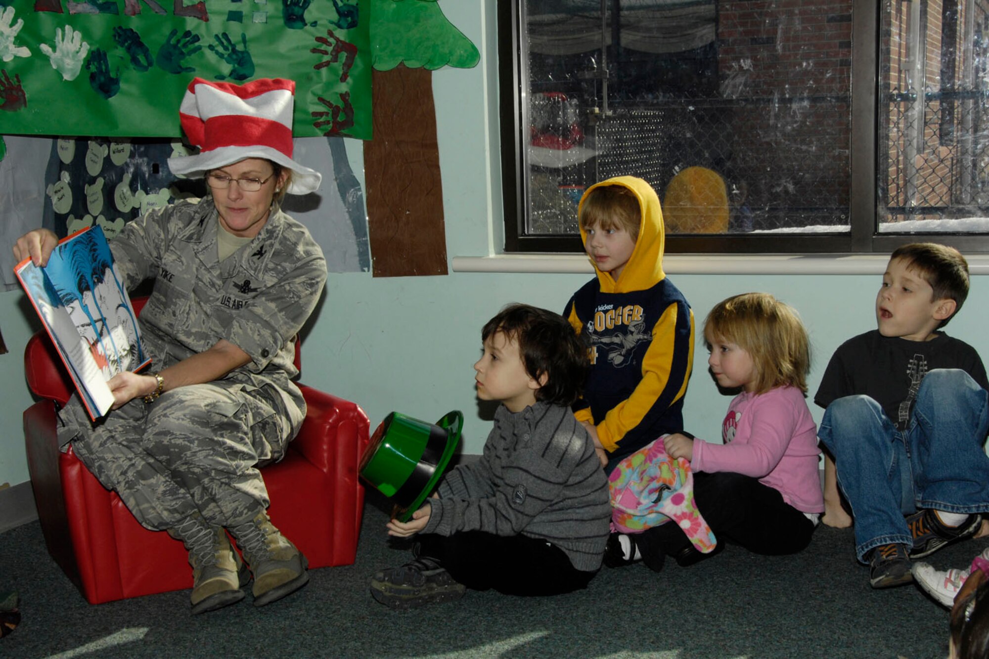 HANSCOM AIR FORCE BASE, Mass. – Col. Stacy L. Yike (left), 66th Air Base Group commander, reads “Horton Hears A Who” by Dr. Seuss to children at the Child Development Center on March 4. Many volunteers, including base leadership, visited the CDC last week to read to kids as part of Read Across America, which coincides with Dr. Seuss’ birthday. (U.S. Air Force photo by Linda LaBonte Britt)