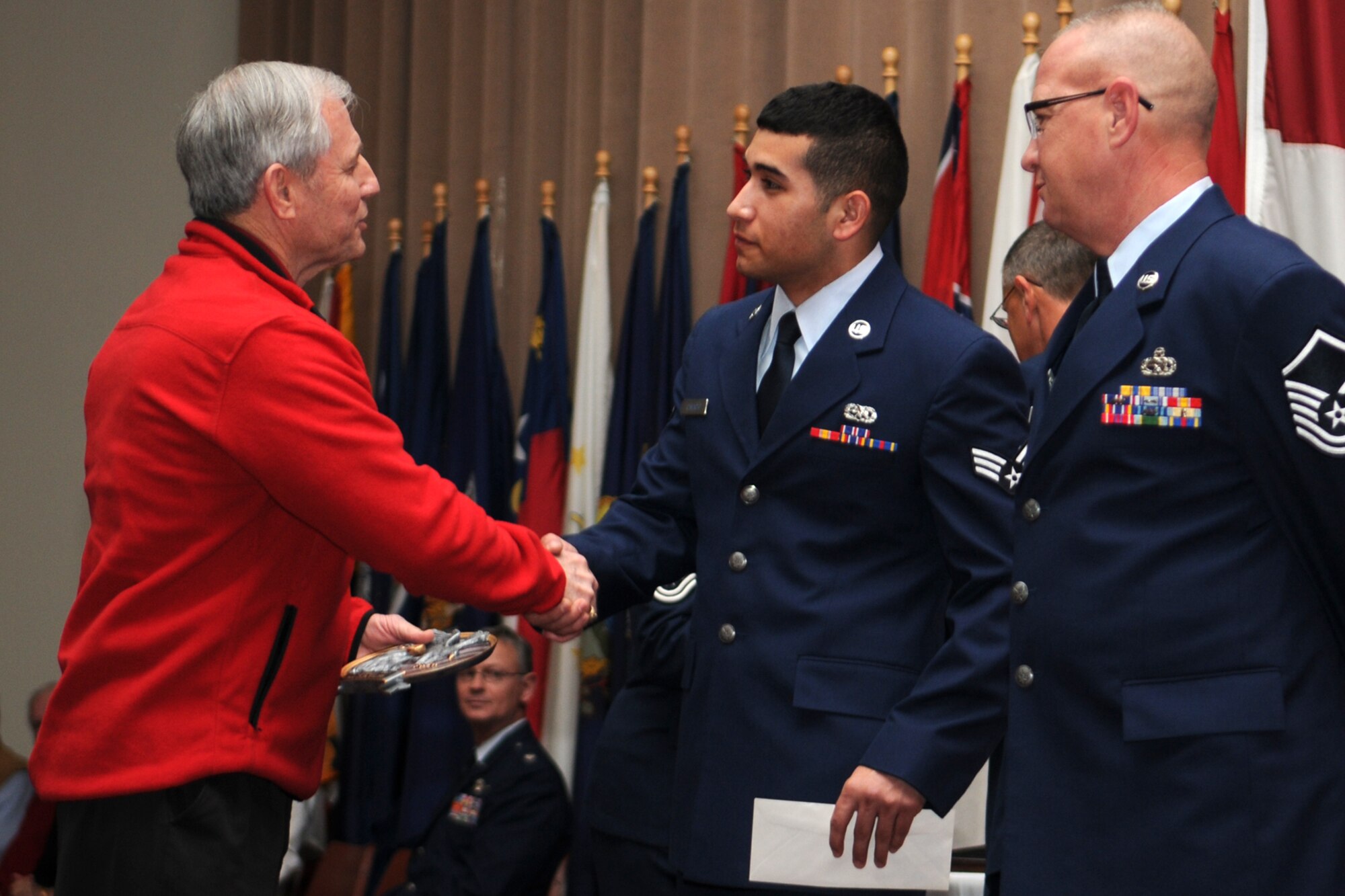Chief Master Sgt. (Ret) Jack Skaggs, a former command chief for the 917th Wing, congratulates Airman 1st Class Juan Camacho, aircraft armament systems mechanic, 307th Aircraft Maintenance Squadron, during the first ever “Barksdale Reserve Awards Ceremony” at Hoban Hall on Barksdale Air Force Base, La., March 6, 2011. Airman Camacho was chosen as the 917th Wing’s Airman of the Quarter for the period covering October to December 2010. The awards ceremony was the first to be held since the deactivation of the 917th Wing, and reactivation of the 307th Bomb Wing. It brings together all of the Reserve components at Barksdale AFB to recognize the accomplishments of their Airmen. (U.S. Air Force photo/Master Sgt. Greg Steele)