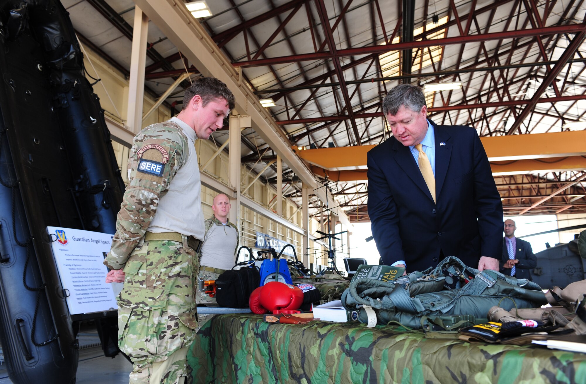 Secretary of the Air Force Michael Donley and Senior Airman Joe Dittmer, 347th Operation Support Squadron Survival Evasion Resistance and Escape specialist, talk about the equipment used for SERE training during the secretary’s visit to Moody Air Force Base, Ga. on March 8, 2011. (U.S. Air Force photo/Senior Airman Stephanie Mancha)(Released)