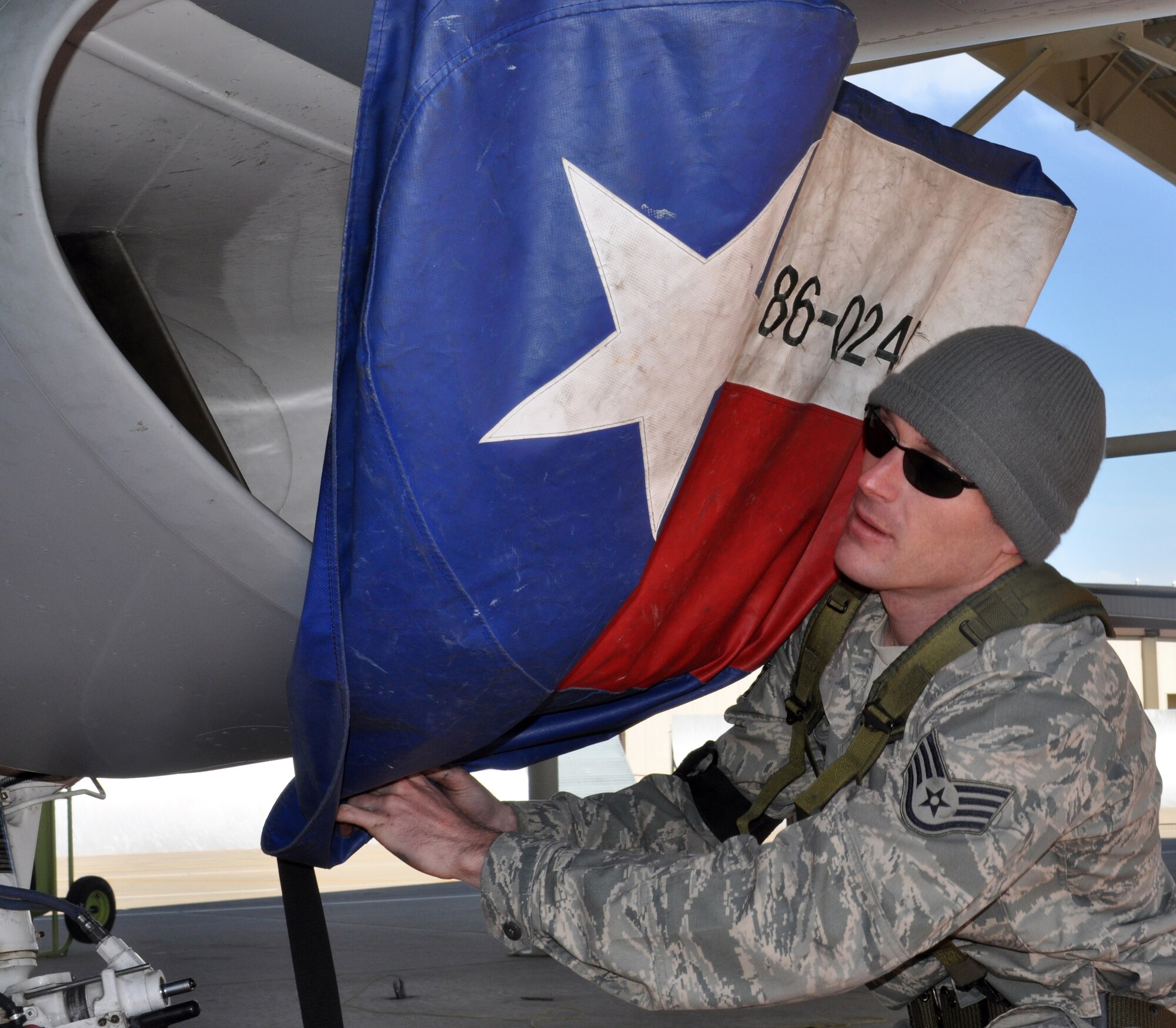 Staff Sgt. Taylor Myers covers the engine inlet on an F-16C Fighting Falcon at Naval Air Station Fort Worth Joint Reserve Base, Texas, March 5, during a "surge" exercise.  Sergeant Myers is a crew chief with the 301st Aircraft Maintenance Squadron.  The exercise was held to prepare the 301st Fighter Wing for an upcoming operational readiness inspection.  The 301st Maintenance Group launched 38 sorties during the one-day surge.  (U.S. Air Force photo/Lt. Col. David Kurle)