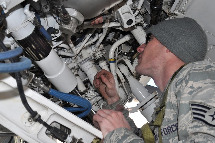 Staff Sgt. Taylor Myers checks for leaking hydraulic lines in the main wheel well of an F-16C Fighting Falcon at Naval Air Station Fort Worth Joint Reserve Base, Texas, March 5.  Sergeant Taylor, a crew chief from the 301st Aircraft Maintenance Squadron was performing a "thru-flight" inspection on the aircraft as part of a "surge" exercise to prepare the 301st Fighter Wing for an operational readiness inspection.  The 301st Maintenance Group produced 38 sorties during the one-day surge.  (U.S. Air Force photo/Lt. Col. David Kurle)