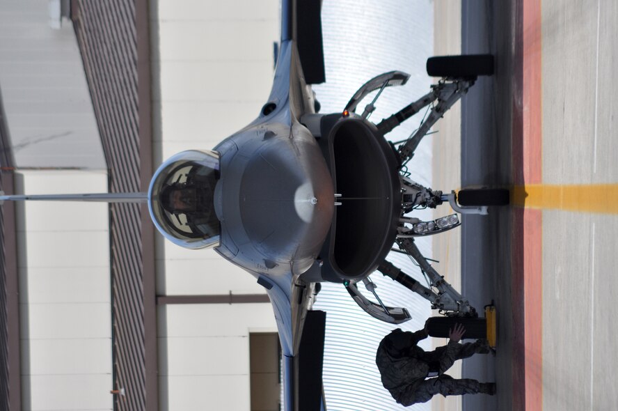 Staff Sgt. Taylor Myers checks for wear and tear on the tires of an F-16C Fighting Falcon at Naval Air Station Fort Worth Joint Reserve Base, Texas, March 5.  Sergeant Myers, a crew chief from the 301st Aircraft Maintenance Squadron, had two hours to "turn," or get the aircraft ready, for its next sortie.  The Air Force Reserve's 301st Fighter Wing held a "surge" exercise to prepare for an upcoming operational readiness inspection.  The 301st Maintenance Group produced 38 sorties in one day, which were flown by pilots in the 457th Fighter Squadron.  (U.S. Air Force photo/Lt. Col. David Kurle)