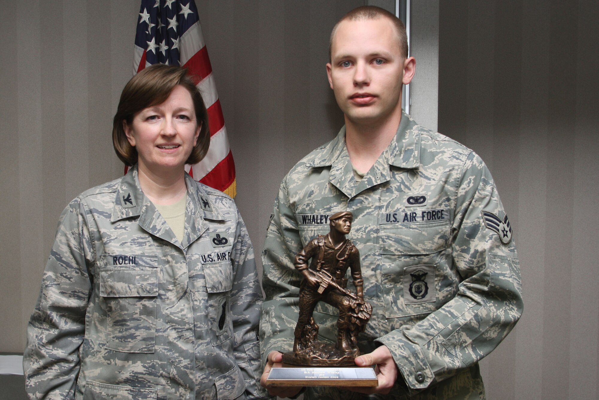 Col. Mary Roehl, Air Force Reserve Command Chief of Security Forces presents the Airman 1st Class Elizabeth N. Jacobson award to Senior Airman Matthew L. Whaley for his accomplishments during his recent deployment to Kirkuk Air Base, Iraq Mar 5. (U.S. Air Force Photo/Don Peek)