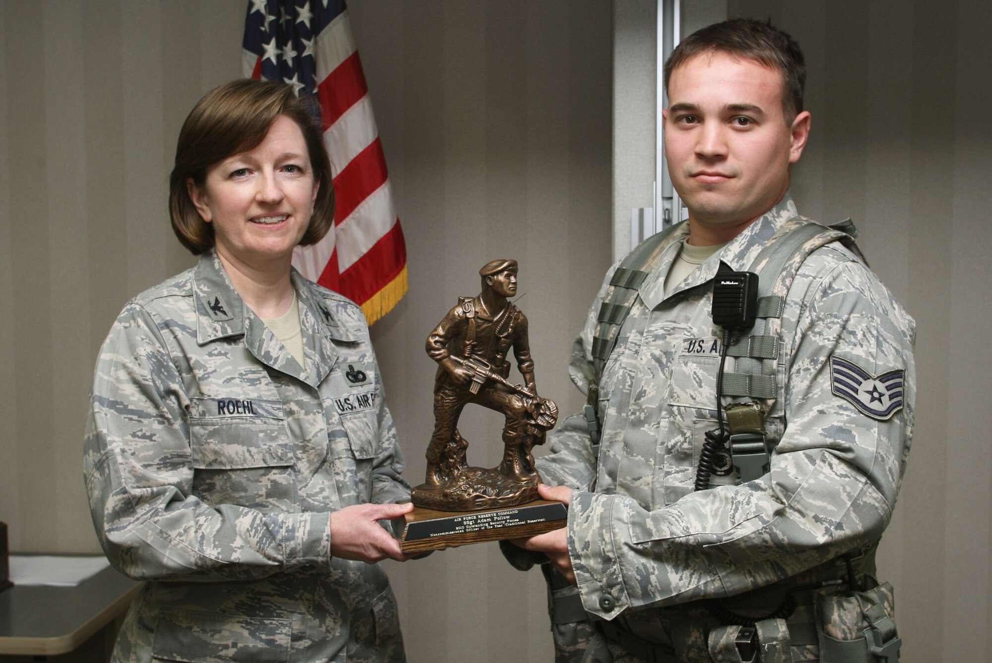 Col. Mary Roehl, Air Force Reserve Command Chief of Security Forces presents the award for the 2010 Outstanding Security Forces Noncommissioned Officer of the Year Traditional Reservist to Staff Sgt. Adam Pollow from the 94th Security Forces Squadron Mar 5. (U.S. Air Force Photo/Don Peek)