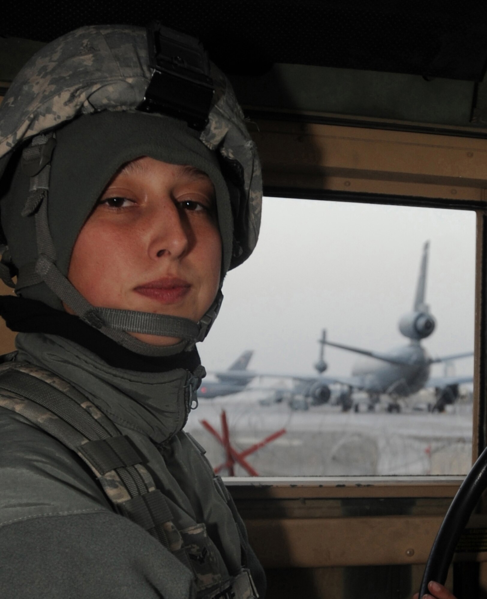 Airman 1st Class Ashley Beattie, 380th Expeditionary Security Forces Squadron, patrols around the flight line in a Humvee Feb. 18, 2011, in Southwest Asia. Keeping Security Forces on 24-hour watch helps minimize the frequency of threats on base. Airman Beattie is deployed from the 436th SFS, Dover AFB, Del. (U.S. Air Force photo by Senior Airman Maynelinne De La Cruz)