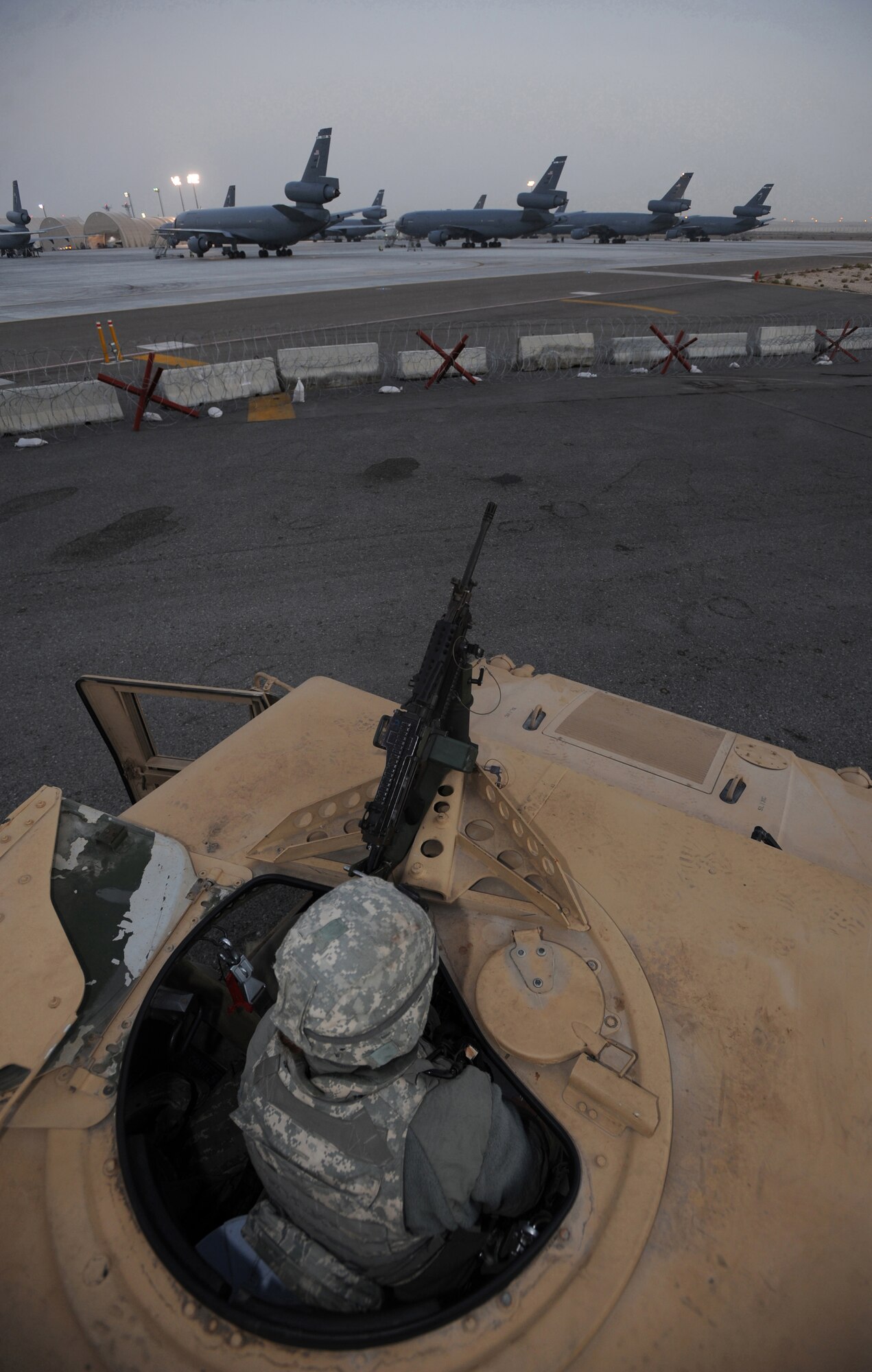 Airman 1st Class Caitlin Chamberlain, 380th Expeditionary Security Forces Squadron, patrols the flight line in the early morning hours, Feb. 18, 2011, in Southwest Asia. Keeping Security Forces on 24-hour watch helps minimize the frequency of threats on base. Airman Chamberlain is deployed from the 75th SFS, Hill AFB, Utah. (U.S. Air Force photo by Senior Airman Maynelinne De La Cruz)