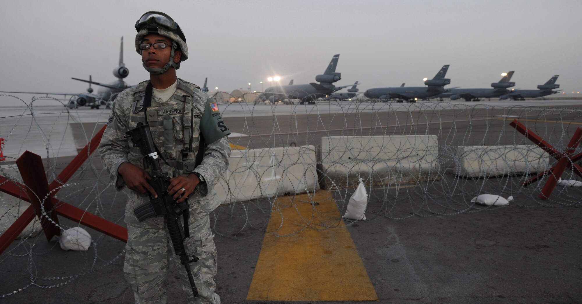 Airman 1st Class Jovan Harewood, 380th Expeditionary Security Forces Squadron, patrols the area Feb. 18, 2011, to ensure zero flight line violations. Security Forces are on 24-hour watch at every post, keeping the installation secure. Airman Harewood is deployed from the 95th SFS, Edwards AFB, Calif. (U.S. Air Force photo by Senior Airman Maynelinne De La Cruz)