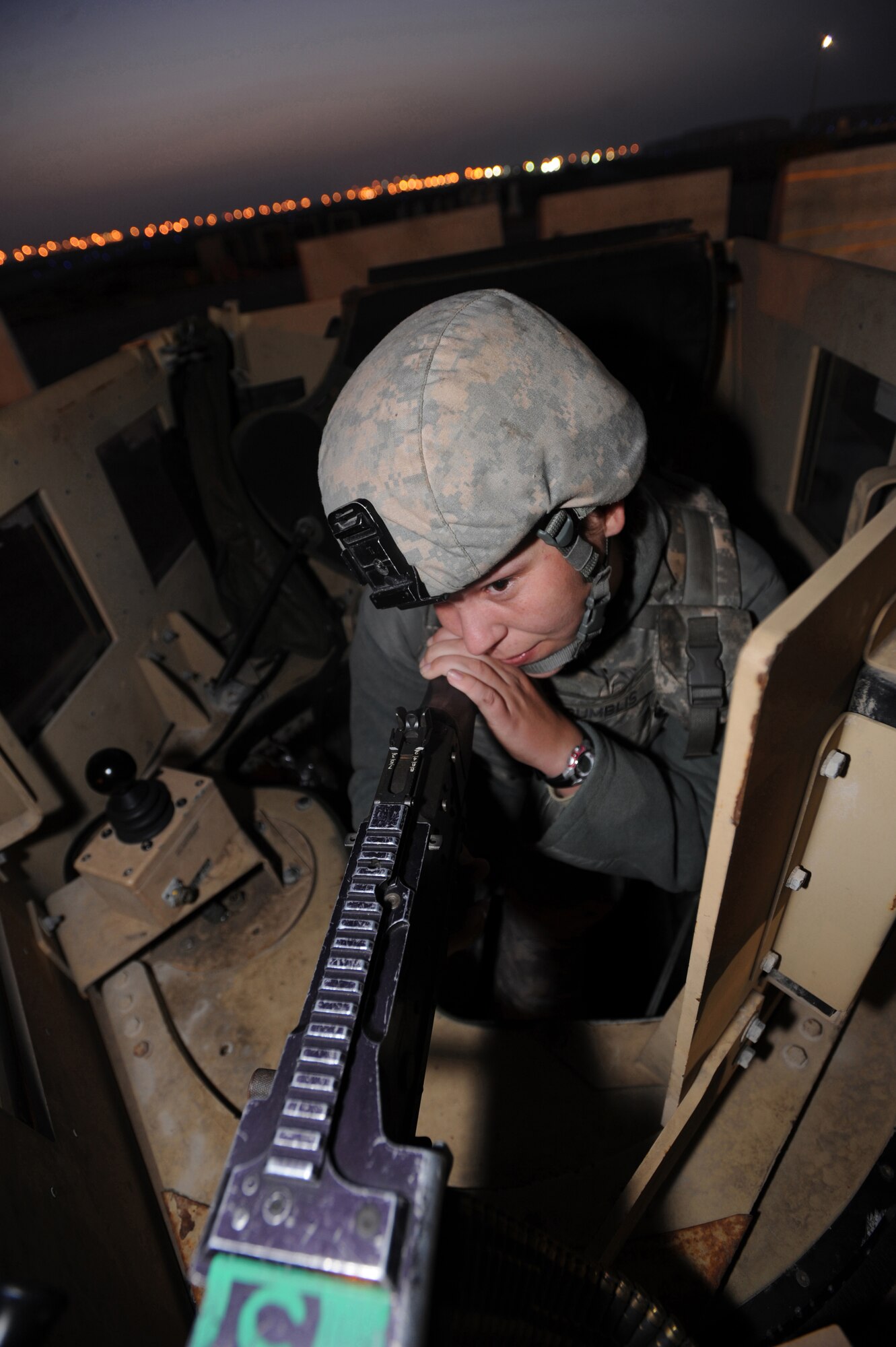 Airman 1st Class Star Bumblis, 380th Expeditionary Security Forces Squadron, keeps a vigilant eye on one of the gates Feb. 18, 2011, in Southwest Asia. Keeping Security Forces on 24-hour watch helps minimize the frequency of threats on the base. Airman Bumblis is deployed from the 95th SFS, Edwards AFB, Calif. (U.S. Air Force photo by Senior Airman Maynelinne De La Cruz)