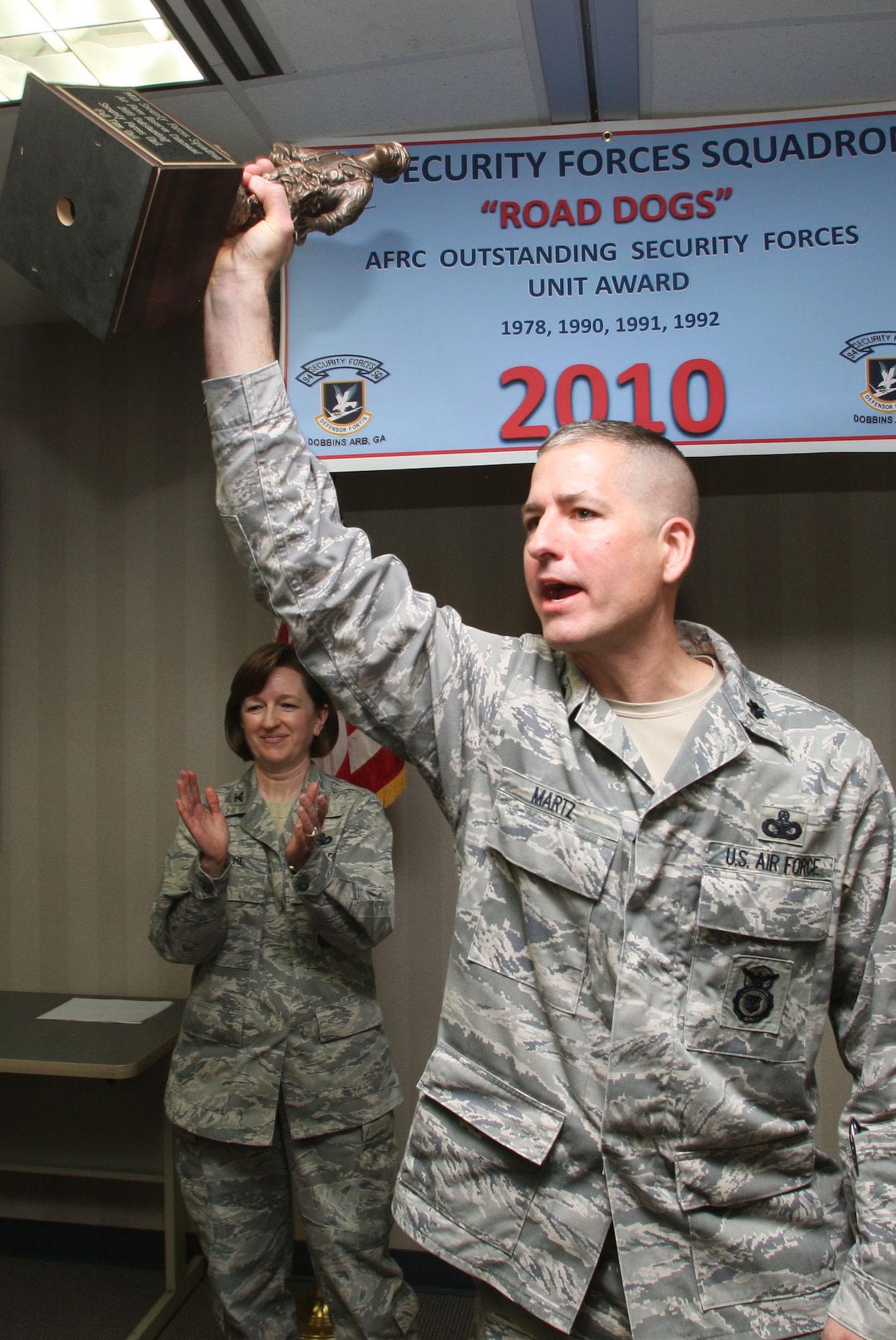 Lt. Col. Timothy H. Martz Commander of the 94th Security Forces Squadron celebrates after the unit received the trophy for the 2010 Air Force Reserve Command Outstanding Security Forces of the Year here Mar 5. (U.S. Air Force Photo/Don Peek)