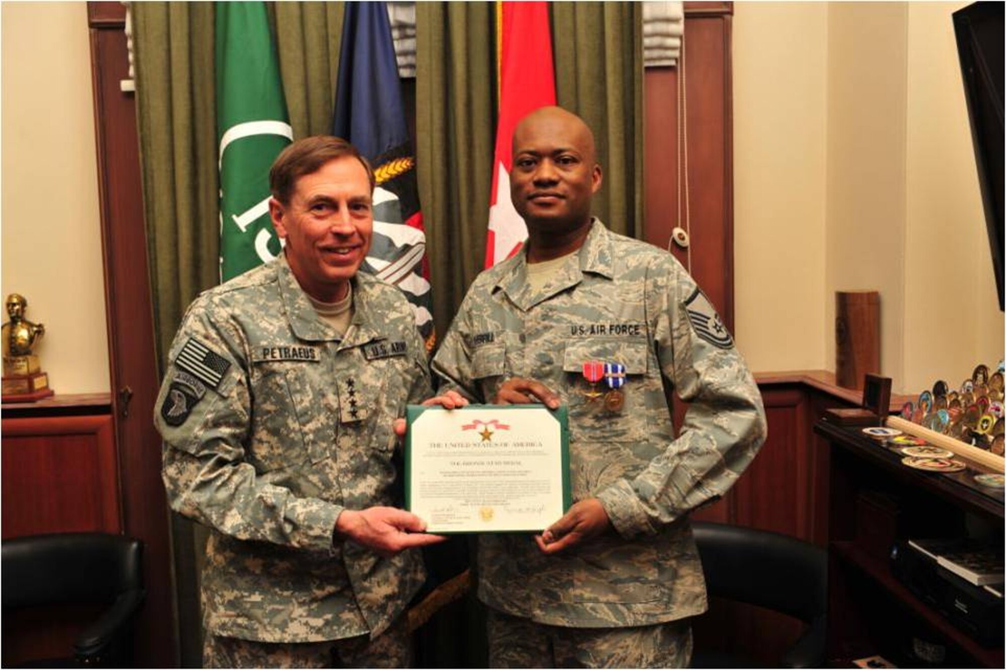 Army Gen. David H. Petraeus, International Security Assistance Force and U.S. Forces Afghanistan commander, presents Master Sgt. Kenneth D. Sherrill, 1st Communications Maintenance Squadron plans and resources flight chief, with a Bronze Star Medal. During his six-month deployment, Sergeant Sherrill was the communications superintendant for General Petraeus and other senior leadership throughout Afghanistan. (Courtesy Photo)