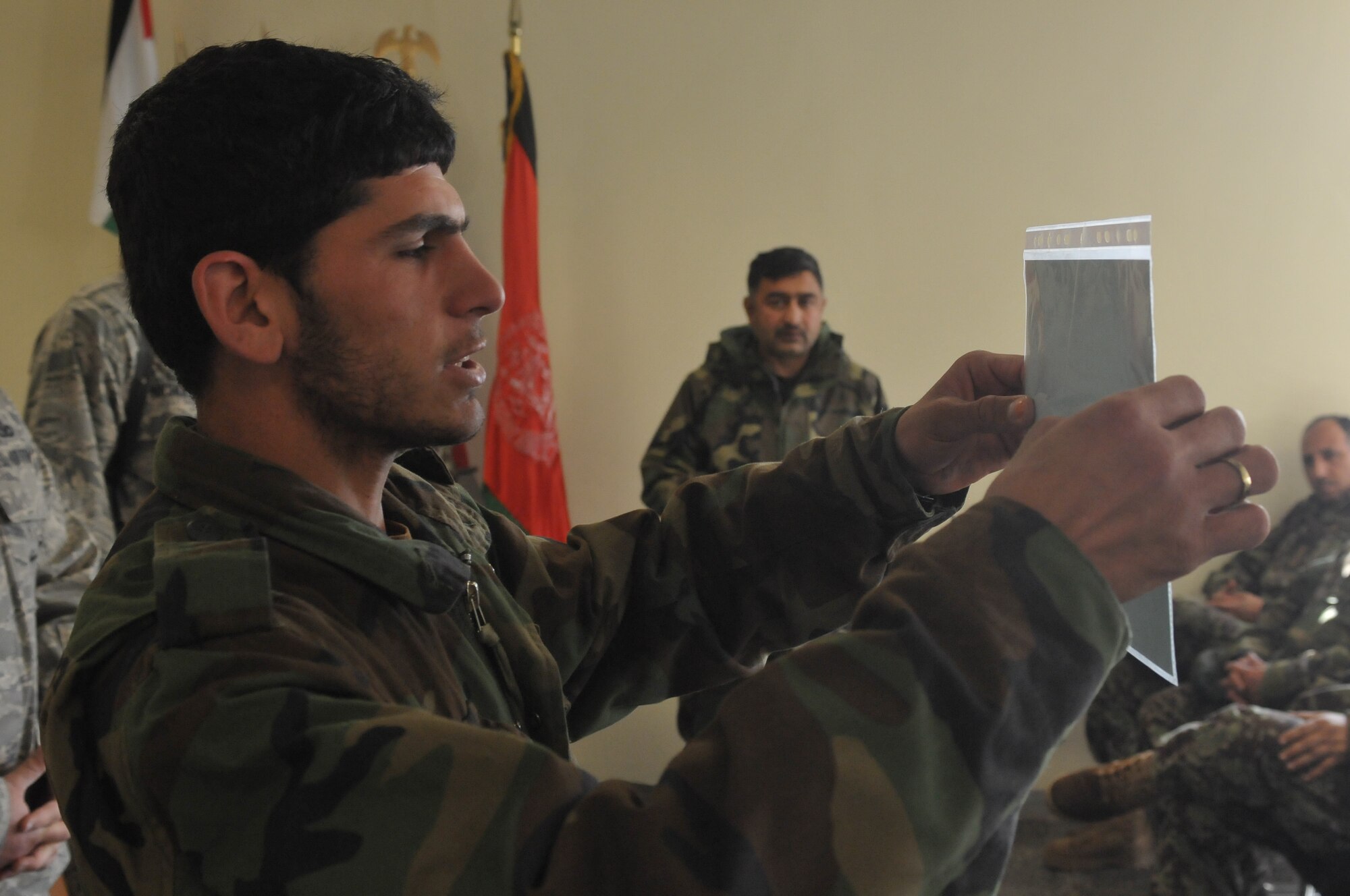 KABUL, Afghanistan -- An Afghan Air Force Airmen presents his graduation certificate during a ceremony honoring him and his fellow security forces course graduates held at Pohantoon-e-Hawayee, the AAF’s “Big Air School,” on the Afghan Air Force Base in Kabul March 7. (U.S. Navy photo by Mass Comunications Specialist 2nd Class Vladimir Potapenko)