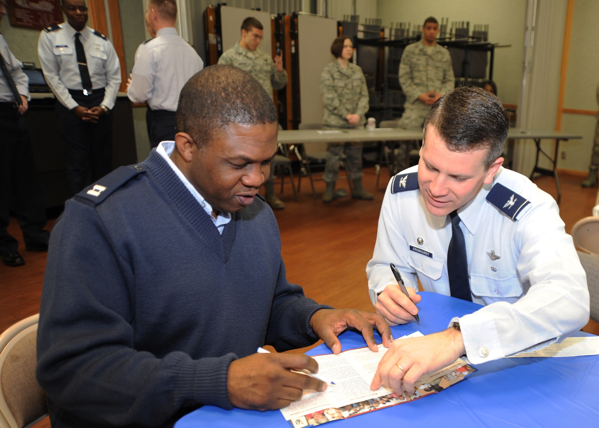 Capt. Joseph Lett, 22nd Force Support Squadron Manpower and Personnel flight commander and McConnell Air Force Assistance Fund installation project officer, assists Col. Jamie Crowhurst, 22nd Air Refueling Wing commander, fill out an AFAF donation slip during the McConnell AFAF kick-off breakfast at the base chapel March 7, 2011, McConnell Air Force Base, Kan. Contributions to the AFAF provide homes and financial assistance to surviving spouses of retired Air Force members. In 2010, 149 Team McConnell members were assisted by the Air Force Aid Society. (U.S. Air Force photo/Senior Airman Maria A. Ruiz)