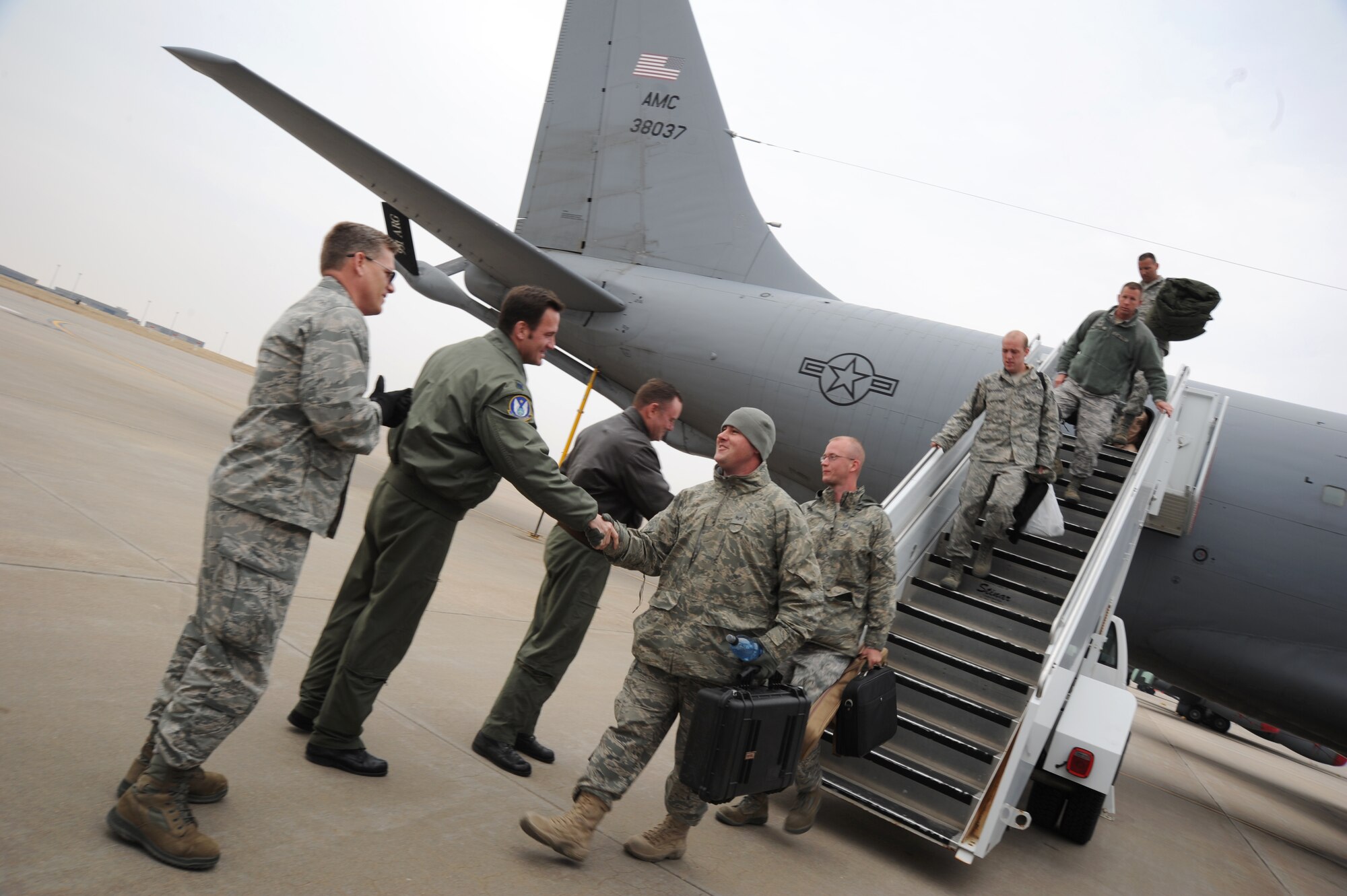 Lt. Col. Jeff Pickard, 931st Air Refueling Group deputy commander of maintenance, Lt. Col. Mike Schlotterback, 18th Air Refueling Squadron assistant operations officer and Col. Daniel Heires, 931st Air Refueling Group deputy commander, shake the hands of 931st ARG Airmen returning from a deployment March 4, 2011, McConnell Air Force Base, Kan. Twenty-one reservists returned from military operations in Southwest Asia. Approximately 50 maintenance, air operations and civil engineer reservists Airmen returned from various locations from March 4-6. 