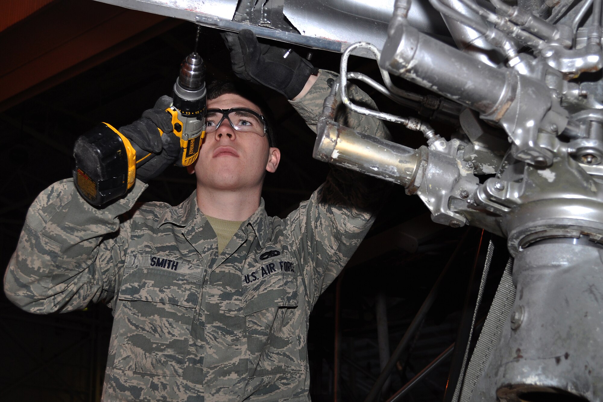 JOINT BASE MCGUIRE-DIX-LAKEHURST, N.J. -- Airman 1st Class Steven Smith, 305th Maintenance Squadron, repairs part of the exterior body of a C-118 Liftmaster in an aircraft maintenance hangar here March 4, 2011. Liftmasters were the first cargo airplanes stationed here and helped the base to define its role as an air mobility gateway. The C-118 is being restored by active-duty Airmen, Reserve Airmen and civilians in an effort to return the aircraft to its position as a static display on the traffic circle near the passenger terminal here. (U.S. Air Force photo/Tech. Sgt. Shawn J. Jones)