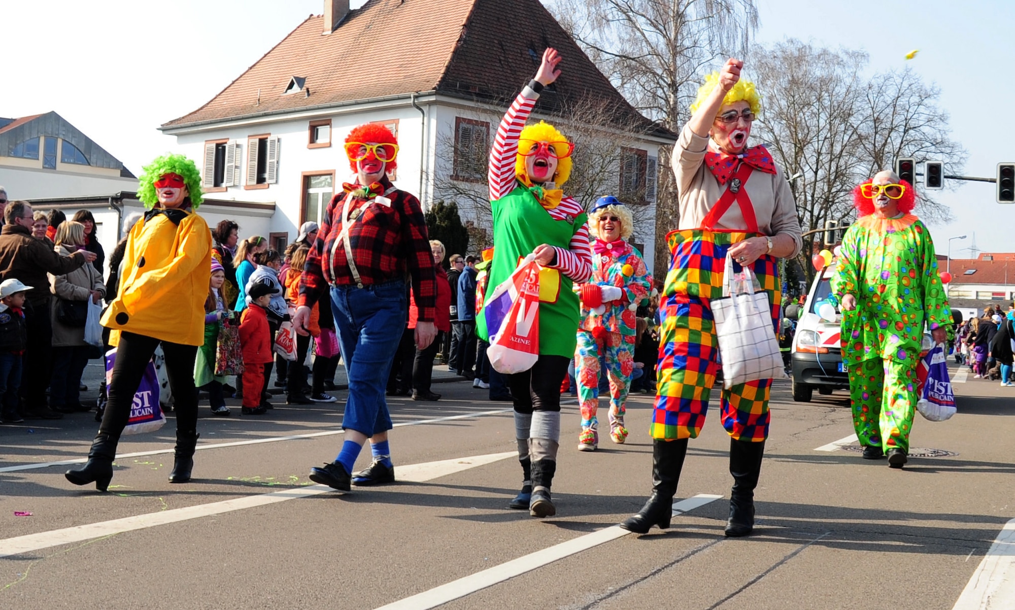 Parade participants dressed as clowns throw candy into the crowd during the annual celebration of Fasching parade, Ramstein village, Germany, March 8, 2011. This annual event is a pre-Lenten carnival which is celebrated with the donning of wild and fancy costumes to chase away the evil spirits of winter in preparation for spring. (U.S. Air Force photo by Senior Airman Brittany Perry)