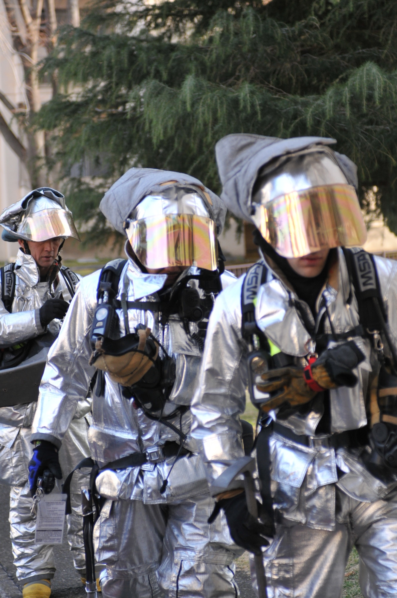YOKOTA AIR BASE, Japan -- Firefighters from the 374th Civil Engineer Squadron fire department, respond to a simulated water contamination incident during an Operational Readiness Exercise here March 9. During the incident, the firefighters escorted personnel from the 374th Aerospace Medicine Squadron bio-environmental engineering office through certain buildings in order to gather water samples for testing. (U.S. Air Force photo/Airman 1st Class Krystal M. Garrett)
