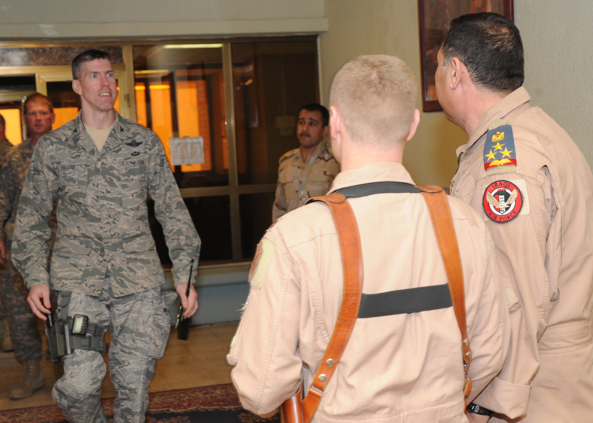 JOINT BASE BALAD, Iraq-- sBG Wamidh (right) looks to greet Col. Christopher Craige (left), 332nd Air Expeditionary Wing vice commander, as he enters the room March 8, 2011. Iraqi air force leaders visited to discuss the future of JBB. (U.S. Air Force photo/ Staff Sgt. Keyonna Fennell)