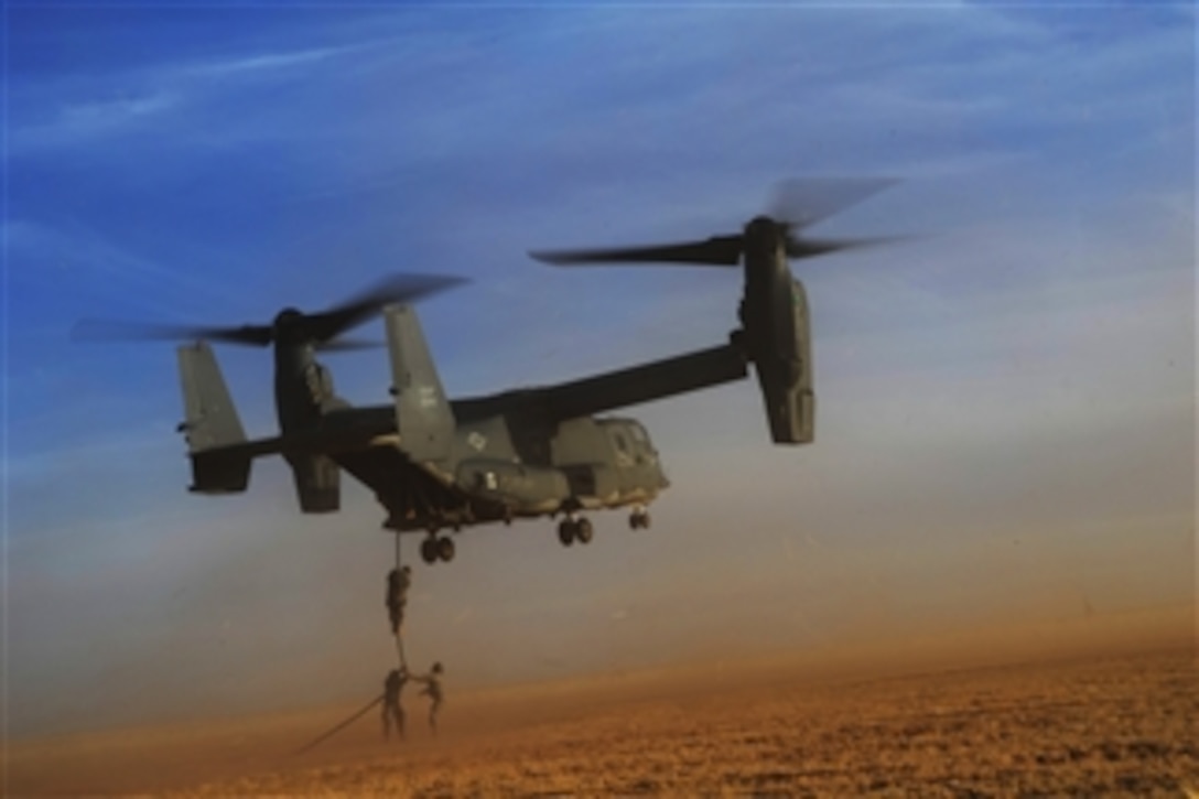 U.S. Army soldiers with Alpha Company, 4th Battalion, 10th Special Forces Group fast-rope from a CV-22 Osprey tiltrotor aircraft during exercise Emerald Warrior 2011 at Cannon Air Force Base, N.M., on March 1, 2011.  Emerald Warrior is an annual two-week joint/combined tactical exercise sponsored by U.S. Special Operations Command designed to leverage lessons learned from operations Iraqi and Enduring Freedom to provide trained and ready forces to combatant commanders.  