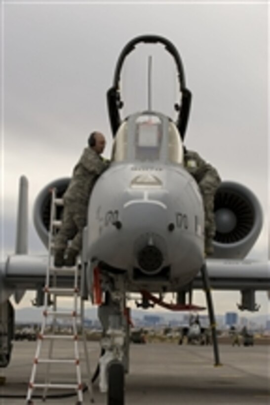 U.S. Air Force Tech. Sgt. Michael Ginzel and Staff Sgt. Michael Hendrickson, 127th Maintenance Squadron crew chiefs, perform interior lighting operations checks on an A-10 Thunderbolt II aircraft during Red Flag 11-3 at Nellis Air Force Base, Nev., on March 1, 2011.  Red Flag is an advanced aerial combat training exercise held four to six times a year to train pilots from the U.S., NATO and other allied countries for real combat situations.  