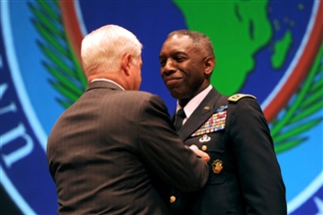 Secretary of Defense Robert M. Gates presents the Defense Distinguished Service Medal to outgoing commander of U.S. Africa Command Army Gen. William Ward during the AFRICOM change of command ceremony at Sindelfingen Stadthalle City Hall in Stuttgart, Germany, on March 9, 2011.  Ward, the first commander of AFRICOM, handed over the reigns to Army Gen. Carter Ham.  