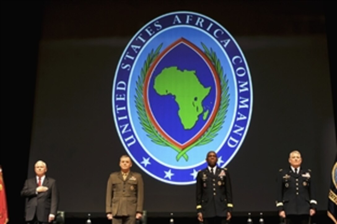 From left to right, U.S. Defense Secretary Robert M. Gates, U.S. Marine Corps Gen. James E. Cartwright, vice chairman of the Joint Chiefs of Staff, U.S. Army Gen. William E. "Kip" Ward, outgoing commander of U.S. Africa Command, and U.S. Army Gen. Carter F. Ham, incoming commander, render honors during the singing of the national anthem at the beginning of the change-of-command ceremony at in Sindelfingen, Germany, March 9, 2011.