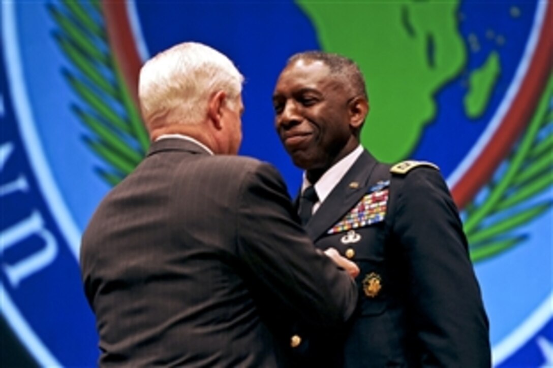 U.S. Defense Secretary Robert M. Gates presents the Defense Distinguished Service Medal to U.S. Army Gen. William E. "Kip" Ward, outgoing commander of U.S. Africa Command, during the change-of-command ceremony in Sindelfingen, Germany, March 9, 2011. Ward, the first commander of U.S. Africa Command, handed over the reins to Army Gen. Carter F. Ham.