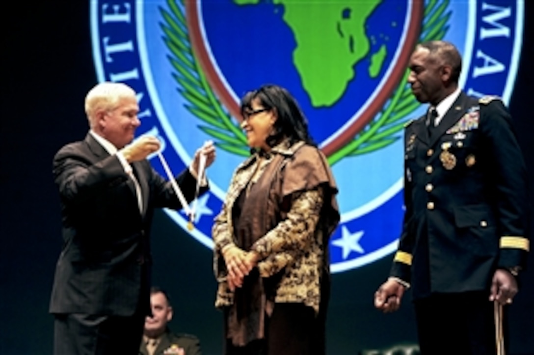 U.S. Defense Secretary Robert M. Gates presents Joyce Ward, wife of U.S. Army Gen. William E. "Kip" Ward, outgoing commander of U.S. Africa Command, with the Distinguished Public Service Award during the change-of-command ceremony in Sindelfingen, Germany, March 9, 2011. Ward handed over the reins of U.S. Africa Command to U.S. Army Gen. Carter F. Ham.