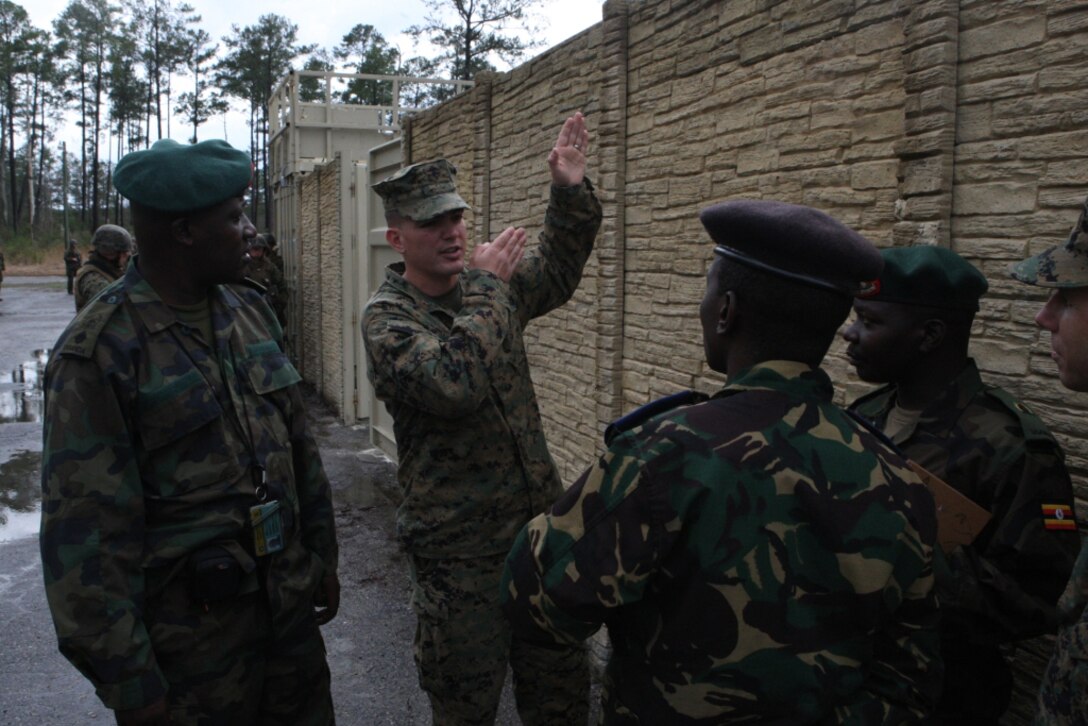 Capt. Alexander Puraty, company commander of Company A, Infantry Training Battalion, School of Infantry – East, explains various patrolling methods utilized by Marines when conducting military operations on urban terrain to military dignitaries from Rwanda, Tanzania and Uganda aboard Camp Geiger, March 11. The dignitaries’ two-day visit to Marine Corps Base Camp Lejeune and satellite installations is part of a three-base amphibious familiarization tour, learning  amphibious assault techniques and observing various training exercises.