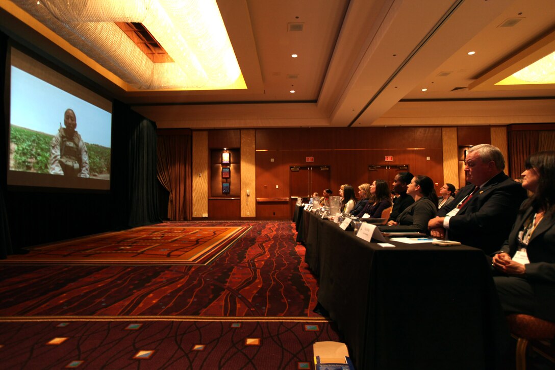 Members of the San Diego Chapter of Women in Defense, watch a video featuring the female engagement team in action in Afghanistan, during the 3rd Annual Women in Defense symposium March 10, in La Jolla, Calif.  Members of the female engagement team were present as guest speakers and shared their experiences with the audience.