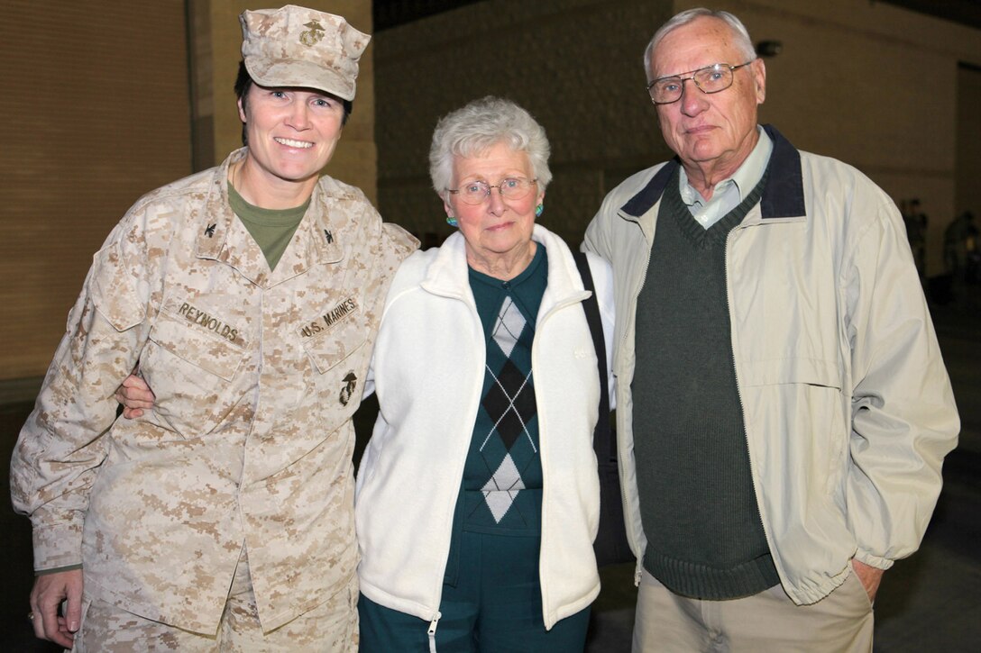 Col. Lori Reynolds, commanding officer of I Marine Headquarters Group, I Marine Expeditionary Force, meets with her family after returning from a year-long deployment to Afghanistan, March 10.