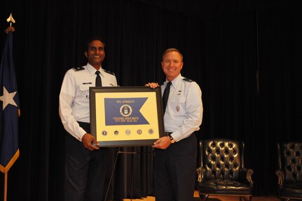 Brig. Gen. Balan Ayyar, HQ Air Force Recruiting Service commander, presents Col. Michael Brice, former HQ AFRS vice commander, with a gift during a farewell luncheon held in Colonel Brice's honor at the Randolph Parr Club March 7. (U.S. Air Force photo by TSgt. Jeff Wolfe) 