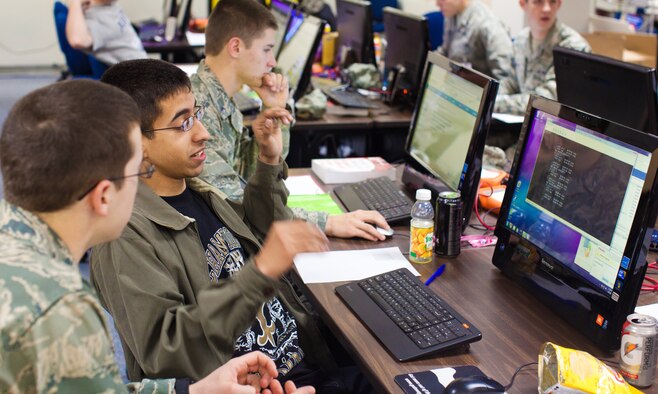 Cadet 4th Class Anthony Canino, left, and Cadet 2nd Class Matthew Toussain discuss network defenses during a National Collegiate Cyber Defense "At Large" regional competition at the Air Force Academy March 6, 2011. The Air Force Academy took first place in the regional event and will compete in nationals April 8-10. Cadet Canino is assigned to Cadet Squadron 12, and Cadet Toussain is assigned to CS 17. (courtesy photo/Jeff Scaparra)