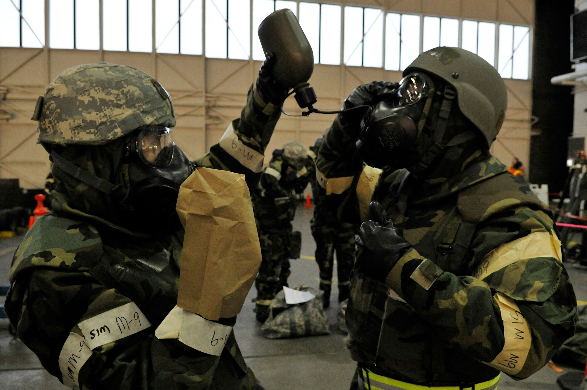 Airmen practice drinking water from canteens through gas masks during an operational readiness exercise evaluation March 10, 2011, Eielson Air Force Base, Alaska.  The evaluation tests the ability of Airmen on how to survive and operate in a chemical, biological, radiological, nuclear and high yield explosive environment. (U.S. Air Force photo/Staff Sgt. Christopher Boitz)