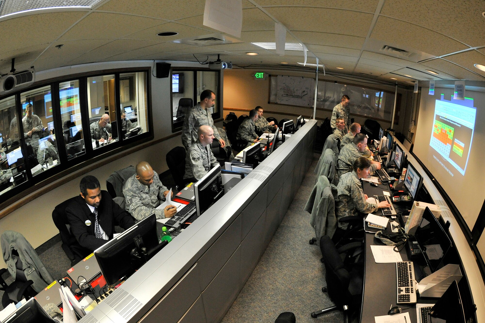Airmen assess an on-base crisis inside the emergency operations center during an operational readiness exercise March 9, 2011, Eielson Air Force Base, Alaska. The exercise is designed to test Airmen's ability to give Airmen experience training in a simulated heightened threat environment while accomplishing the mission. The EOC receives and distributes information between base personnel during emergencies. (U.S. Air Force photo/Staff Sgt. Christopher Boitz)