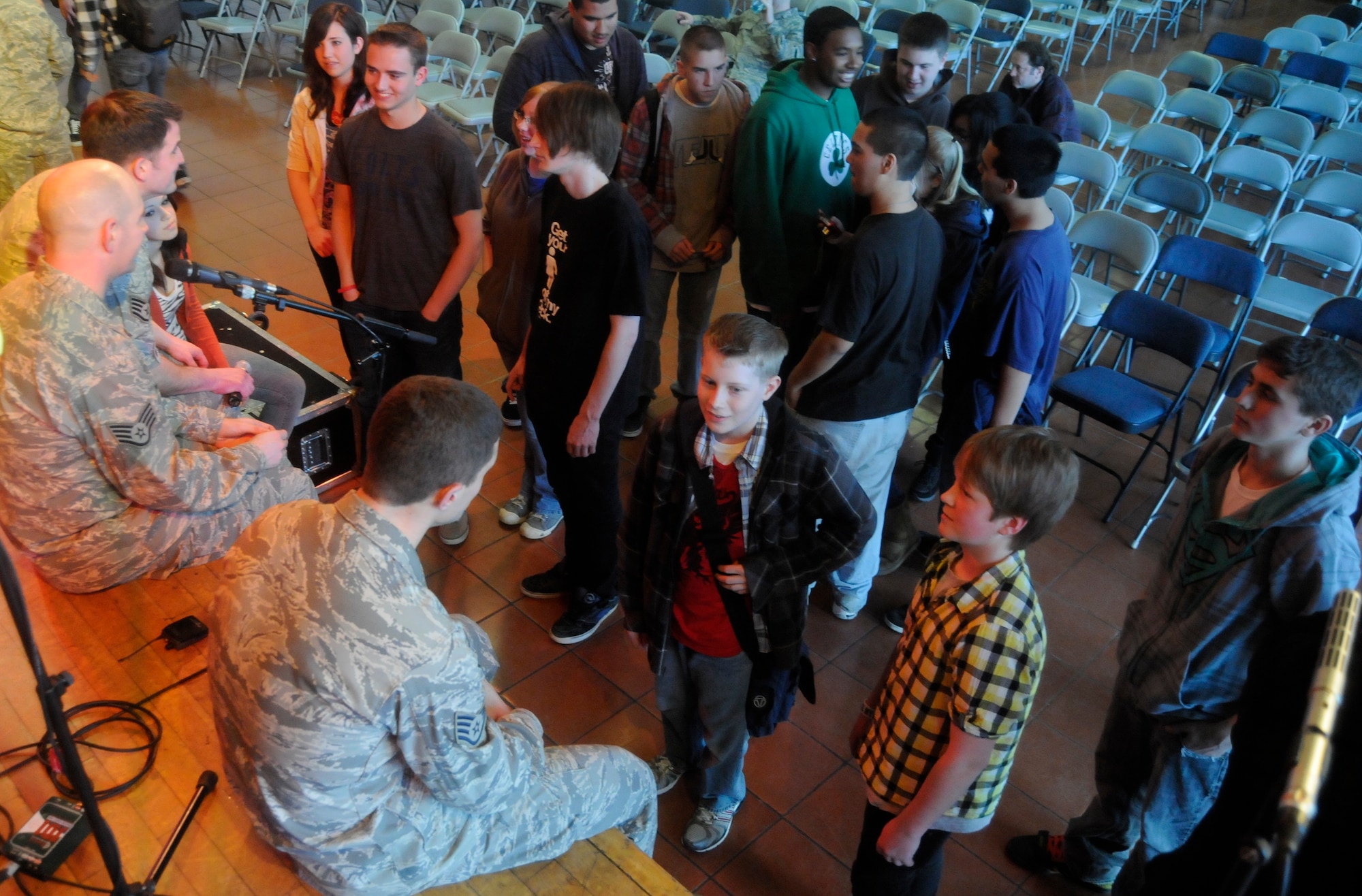 ANSBACH, Germany – From left to right in uniform, Staff Sgt. Craig Bowman, U.S. Air Forces in Europe Band Touch ‘n Go vocalist; Staff Sgt. Jon Friedman, Touch ‘n Go percussionist; and Staff Sgt. Dustin Trimble, Touch ‘n Go guitarist; speak with Ansbach Middle and High School students on U.S. Army Garrison Ansbach, Germany, following a performance March 9. Touch ‘n Go performed before a packed gymnasium of students and teachers at the school as part of a Music in Our Schools tour throughout Bavaria. (U.S. Air Force photo/Staff Sgt. Kali L. Gradishar)