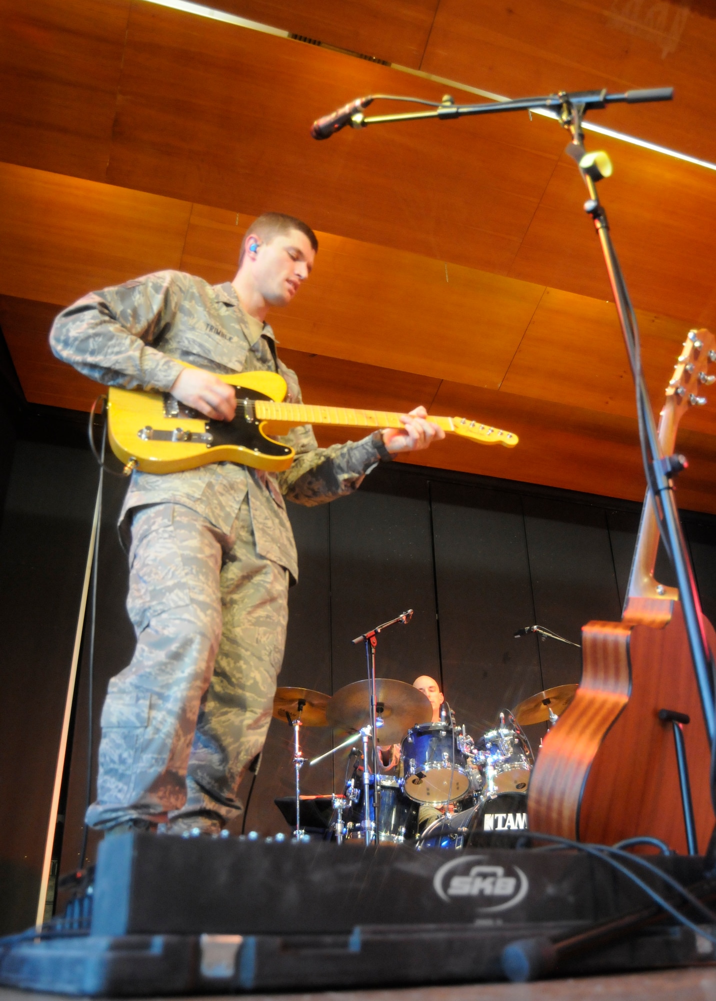 ANSBACH, Germany – Staff Sgt. Dustin Trimble, U.S. Air Forces in Europe Band Touch ‘n Go guitarist, performs for a gymnasium packed with Ansbach Middle and High School students on U.S. Army Garrison Ansbach, Germany, during a performance March 9. Touch ‘n Go performed before a packed gymnasium of students and teachers at the school as part of a Music in Our Schools tour throughout Bavaria. (U.S. Air Force photo/Staff Sgt. Kali L. Gradishar)