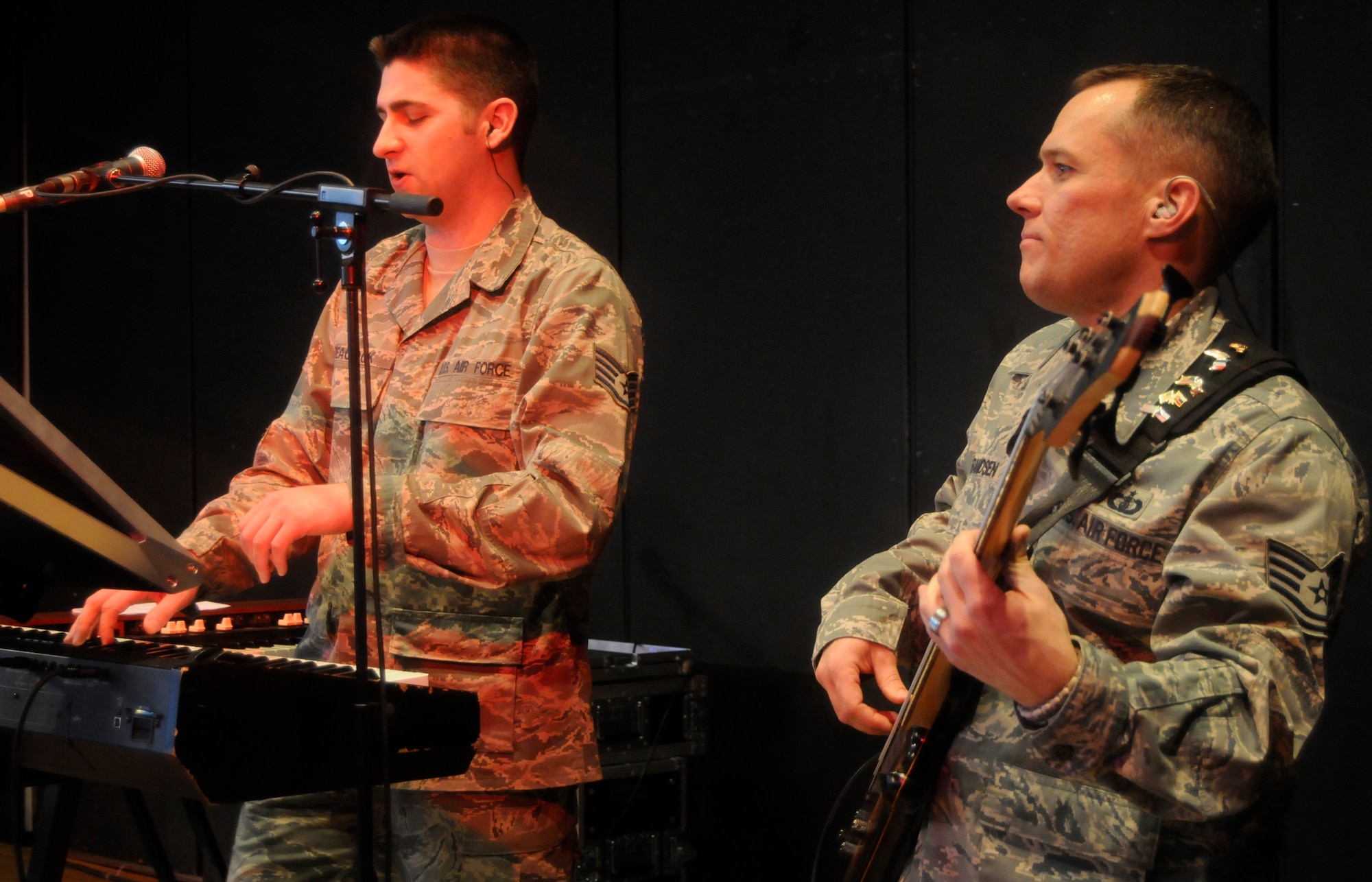 ANSBACH, Germany -- Staff Sgt. Matthew Peacock, U.S. Air Forces in Europe Band Touch ‘n Go pianist (left), and Tech. Sgt. Mark Frandsen, Touch ‘n Go NCO in charge and bassist, perform for a gymnasium packed with Ansbach Middle and High School students on U.S. Army Garrison Ansbach, Germany, during a performance March 9. Touch ‘n Go performed before a packed gymnasium of students and teachers at the school as part of a Music in Our Schools tour throughout Bavaria. (U.S. Air Force photo/Staff Sgt. Kali L. Gradishar)