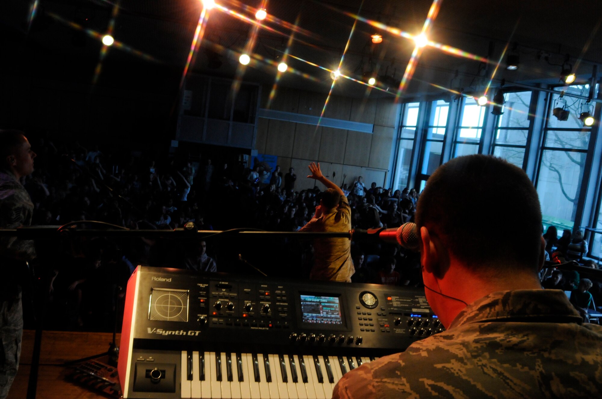 ANSBACH, Germany -- Staff Sgt. Matthew Peacock, U.S. Air Forces in Europe Band Touch ‘n Go pianist, performs for a gymnasium packed with Ansbach Middle and High School students on U.S. Army Garrison Ansbach, Germany, during a performance March 9. Touch ‘n Go performed before a packed gymnasium of students and teachers at the school as part of a Music in Our Schools tour throughout Bavaria. (U.S. Air Force photo/Staff Sgt. Kali L. Gradishar)