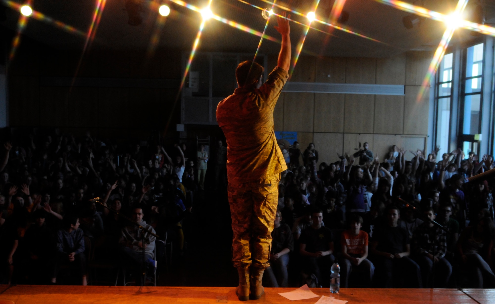 ANSBACH, Germany -- Staff Sgt. Craig Bowman, U.S. Air Forces in Europe Band Touch ‘n Go vocalist, sings to Ansbach Middle and High School students on U.S. Army Garrison Ansbach, Germany, during a performance March 9. Touch ‘n Go performed before a packed gymnasium of students and teachers at the school as part of a Music in Our Schools tour throughout Bavaria. (U.S. Air Force photo/Staff Sgt. Kali L. Gradishar)