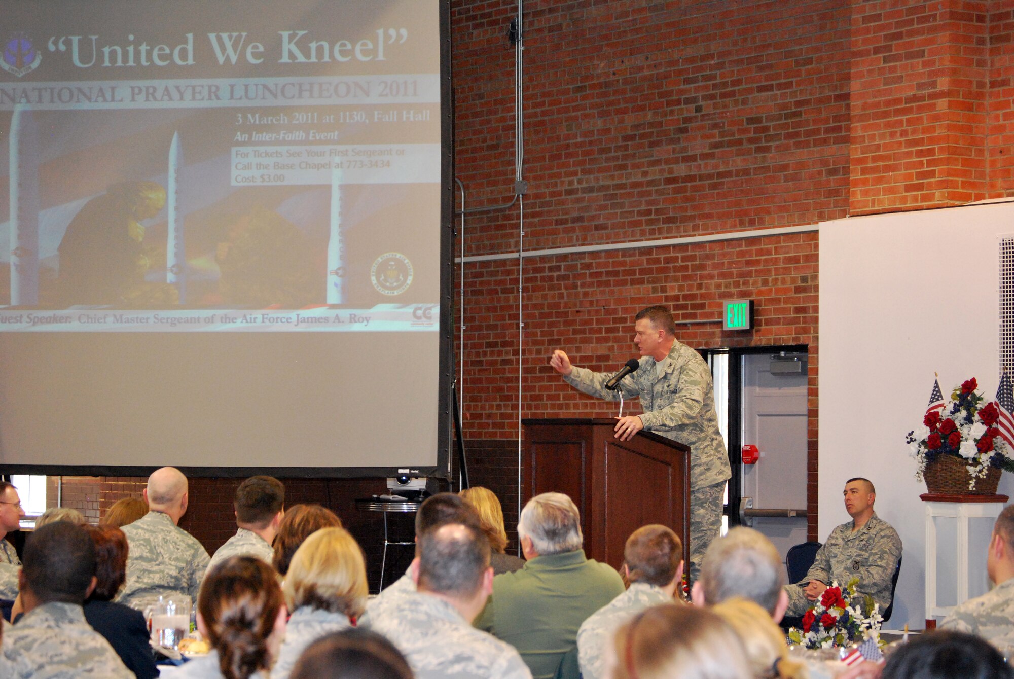 Col. Greg Tims, 90th Missile Wing commander, addresses the audience and thanks Chief Master Sergeant of the Air Force James Roy for speaking at Warren’s National Prayer Luncheon in the Fall Hall Community Center March 3. (U.S. Air Force photo by Tech. Sgt. William Spencer)