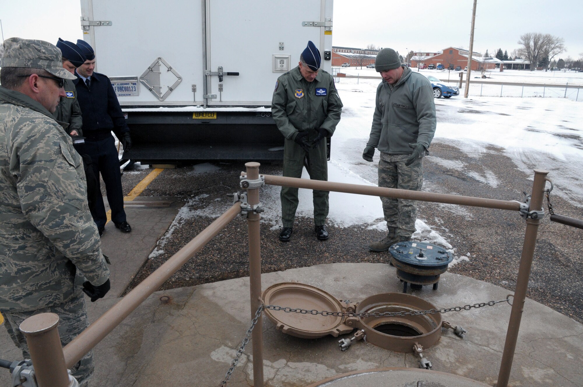 Major General William Chambers, Assistant Chief of Staff for Strategic Deterrence and Nuclear Integration, observes a section of the Uniform-01 training facility as Staff Sgt. Christopher Isenberger, 90th Maintenance Operations Squadron, explains maintenance procedures during the tour, as others look on March 7. (U.S. Air Force photo by Blaze Lipowski)

