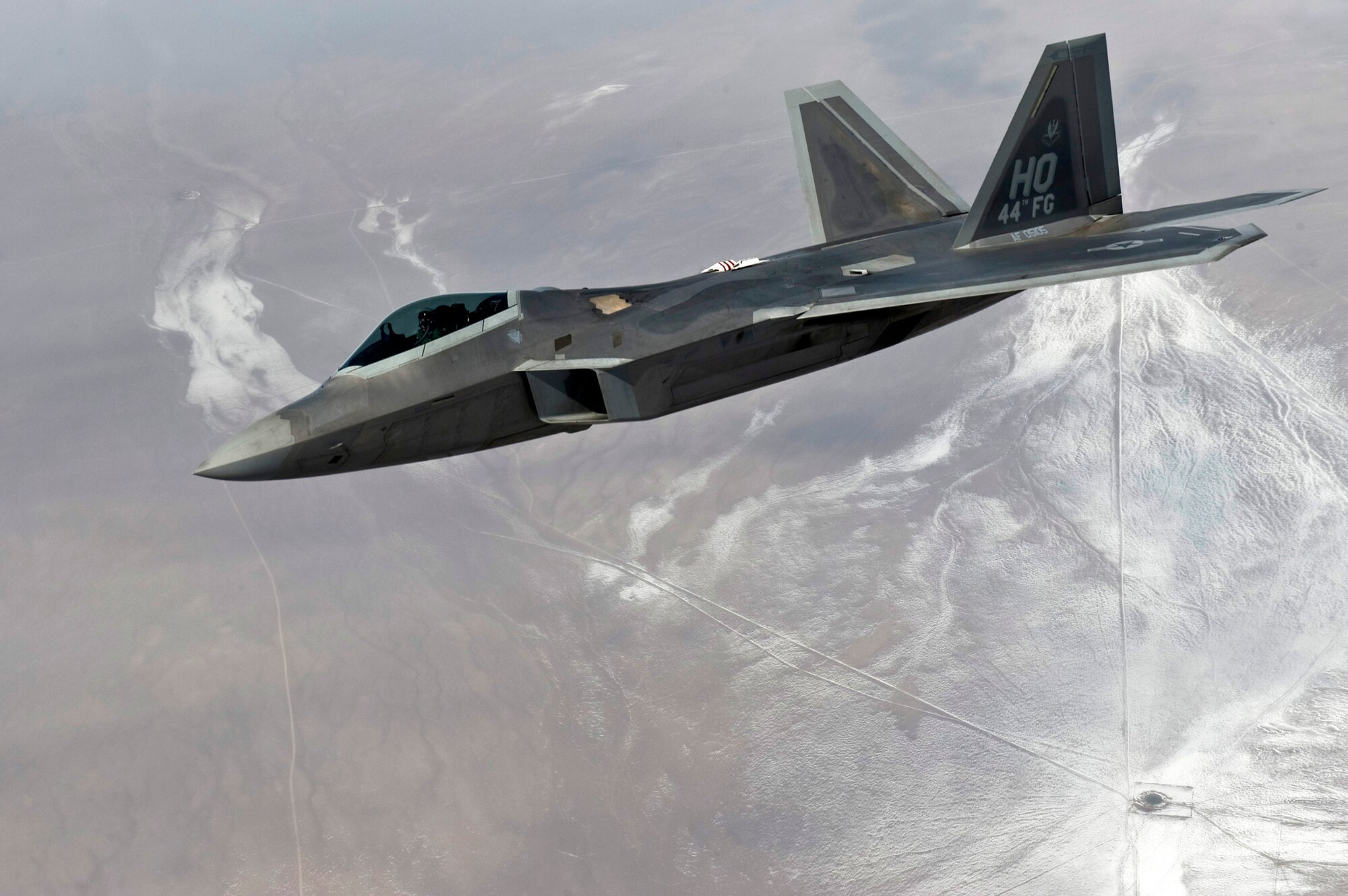 An F-22 Raptor from the 49th Fighter Wing at Holloman Air Force Base, N.M., flies over the Nevada Test and Training Range March 2, 2011, during a Red Flag training mission. (U.S. Air Force photo/Senior Airman Brett Clashman)
