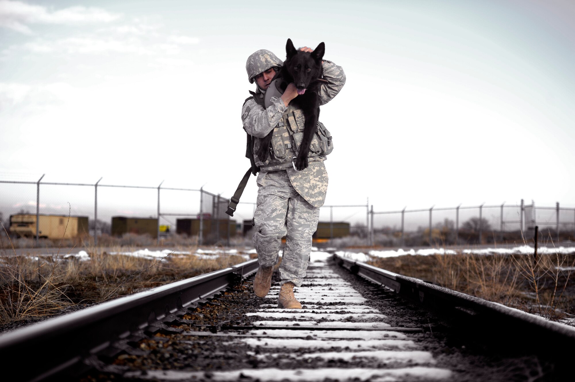 Staff Sgt. Erick Martinez, a military dog handler at Hill Air Force Base, Utah, uses an over-the-shoulder carry with Argo II March 4, 2011.  This exercise helps build trust, loyalty, and teamwork for Sergeant Martinez and Argo II, who have only been working together for only two months. (U.S. Air Force photo/Airman 1st Class Allen Stokes)
