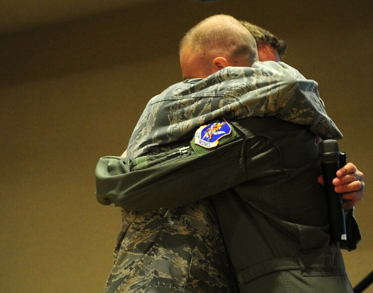 Master Sgt. Robert Disney, 347th Rescue Group superintendent, and Capt. Kyle Deem, 41st Rescue Squadron HH-60G Pave Hawk pilot, both from Moody Air Force Base, Ga., embrace during the wounded warrior presentation March 10. Both Airmen sustained injuries while deployed but lived to share their experiences. (U.S. Air Force photo/Senior Airman Stephanie Mancha)(RELEASED