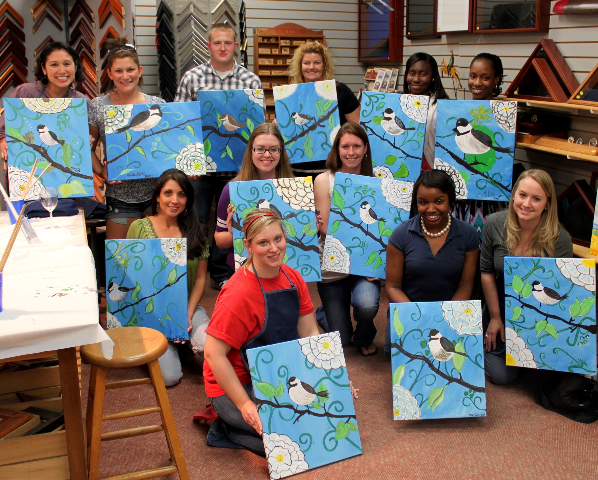 LAUGHLIN AIR FORCE BASE, Texas - Students of an iCANvas Paint! class, instructed by Marie Matelly, Frame and Woodcraft shop picture framer, show off their finished masterpieces. iCANvas is a three hour painting class that provides all the materials needed to walk out of the door with a personal work of art. (Contributed photo)