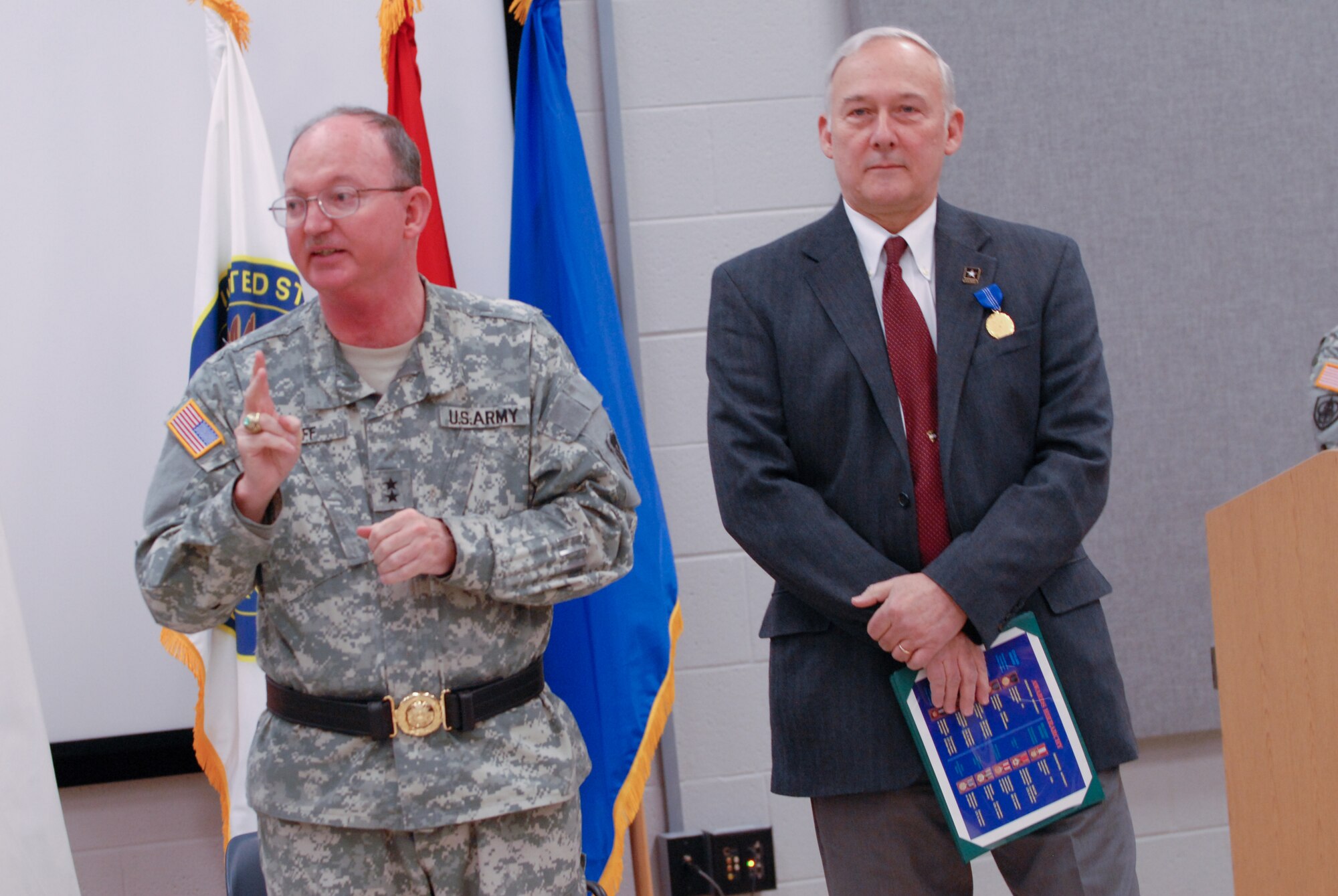 Maj. Gen. William D. Razz Waff talks to a standing-room-only crowd after presenting William M. Staub with the Decoration for Exceptional Civilian Service Award during a ceremony at the Maj. John P. Pryor Armed Forces Reserve Center at Joint Base McGuire-Dix-Lakehurst Feb. 26. The Decoration for Exceptional Civilian Service Award is the highest award granted by the United States Army to civilian personnel. (U.S. Army photo by Sgt. 1st Class Alyn-Michael Macleod/ Released)
