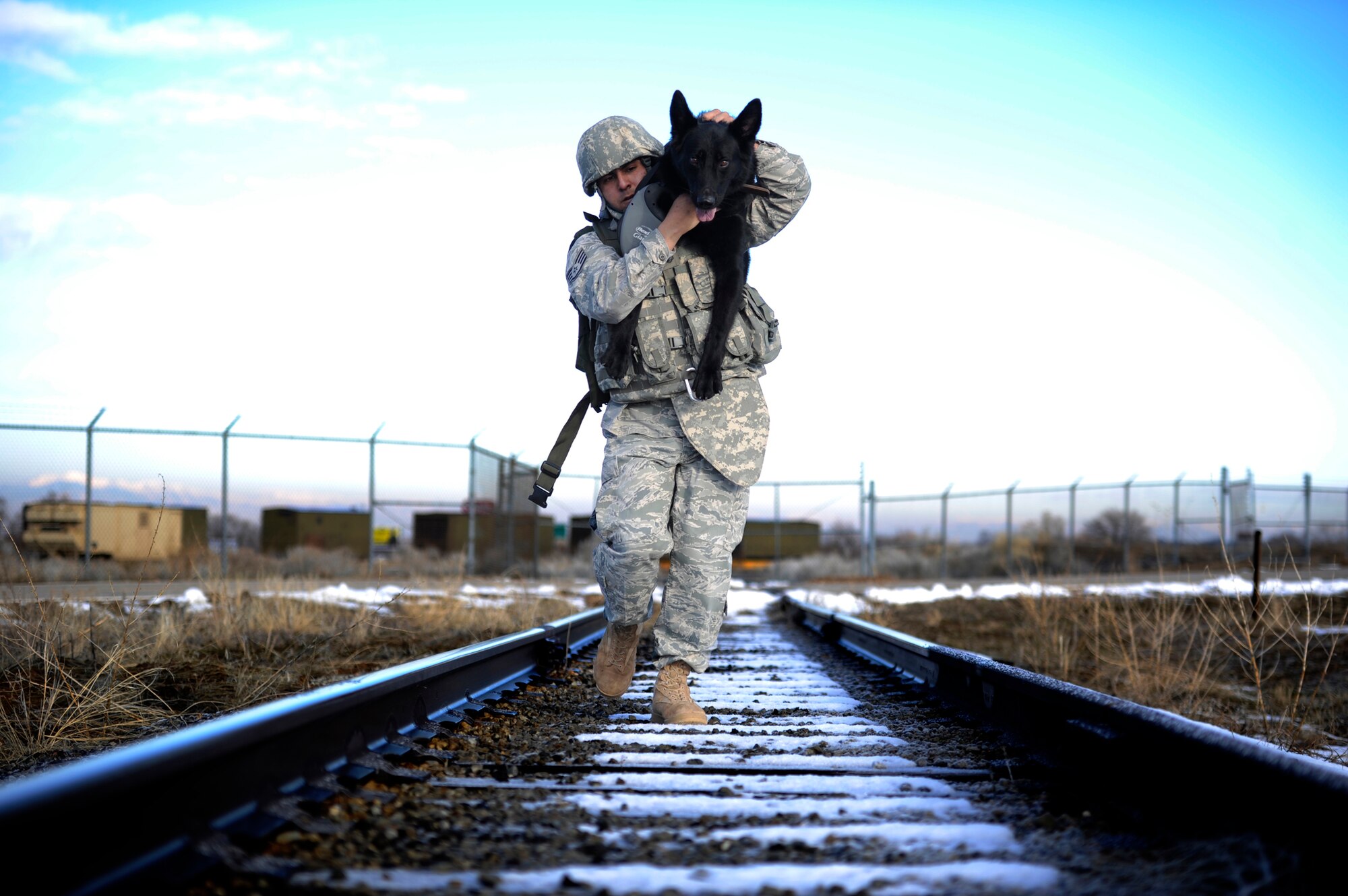 Staff Sgt. Erick Martinez, a military dog handler, uses an over-the-shoulder carry with Argo II March 4, 2011, during an exercise at Hill Air Force Base, Utah. The exercise helps build trust, loyalty and teamwork for Sergeant Martinez and Argo II, who have been working together for only two months. (U.S. Air Force photo/Airman 1st Class Allen Stokes)