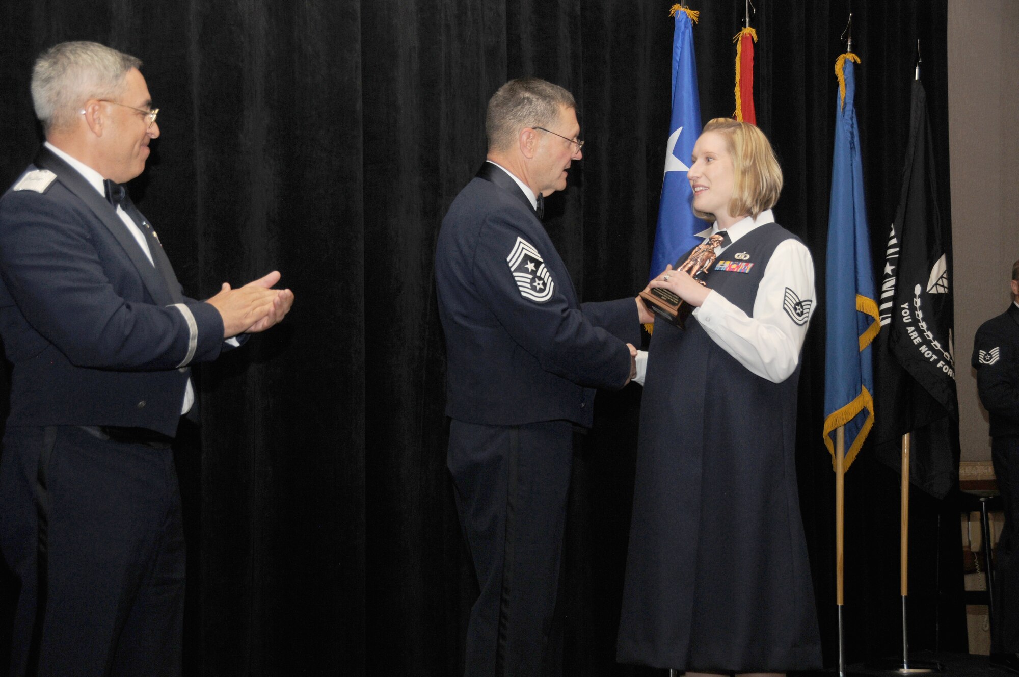 Tech. Sgt. Amanda Lopez from the 107th Air Control Squadron, Phoenix Ariz, is the Arizona Air National Guard’s Noncommissioned Officer of the Year. Sergeant Lopez accepts her award from Arizona State Command Chief Daniel Irving and Brig. Gen. Michael Colangelo, Commander Arizona Air National Guard on Saturday March 5, 2011.  (U.S. Air Force photo by Airman 1st Class Rashaunda Williams/Released)